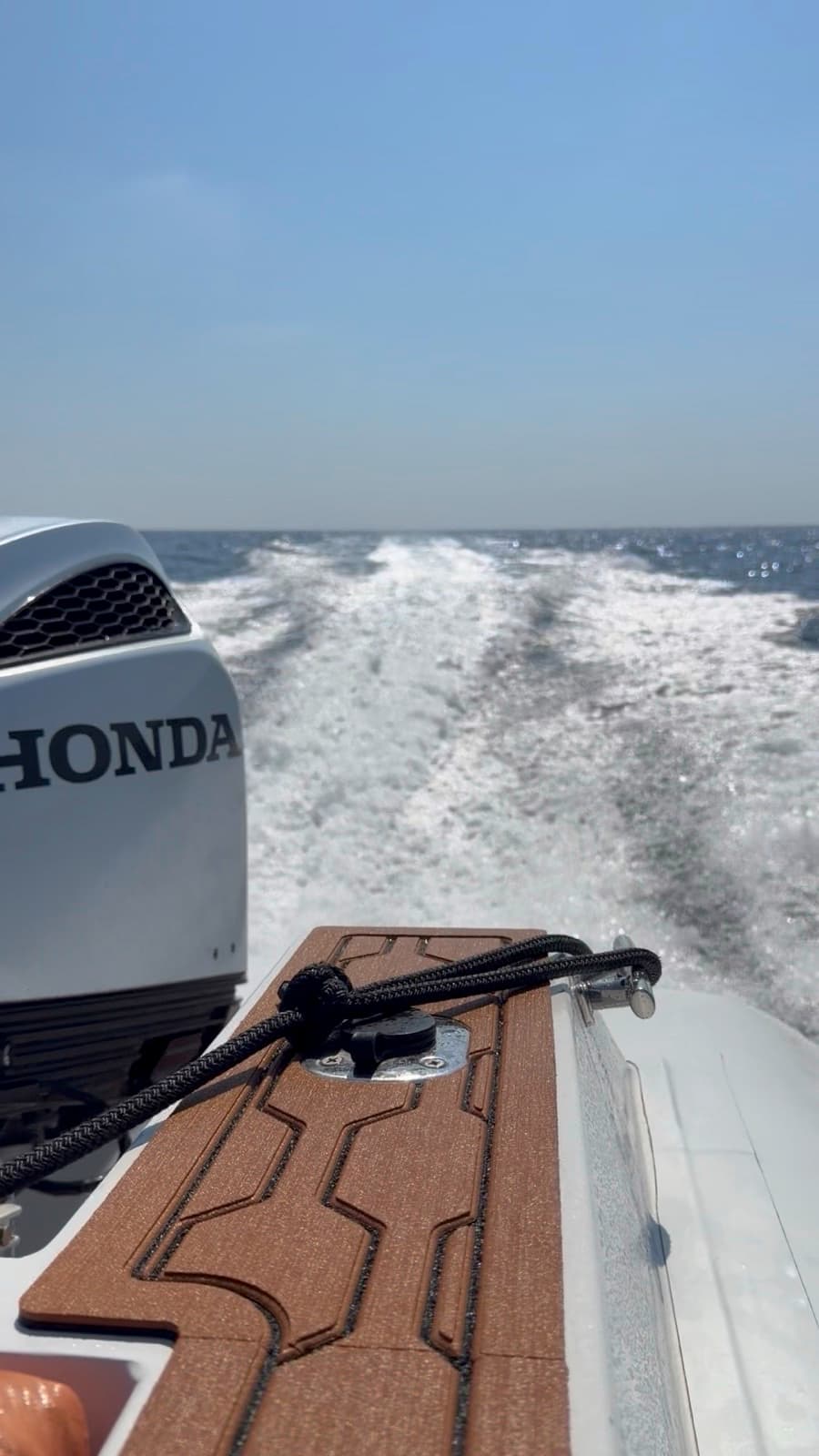 Looking aft over one of the Honda BF250s and the wake, running in open water.